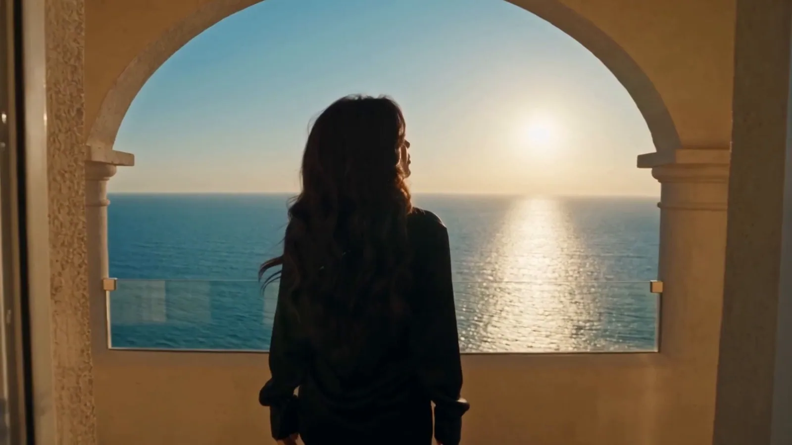 Zora Savić, a virtual AI artist, under a stone arch over the sea in a frame from the AI generated Sunce Moje music video (67 MUSIC)